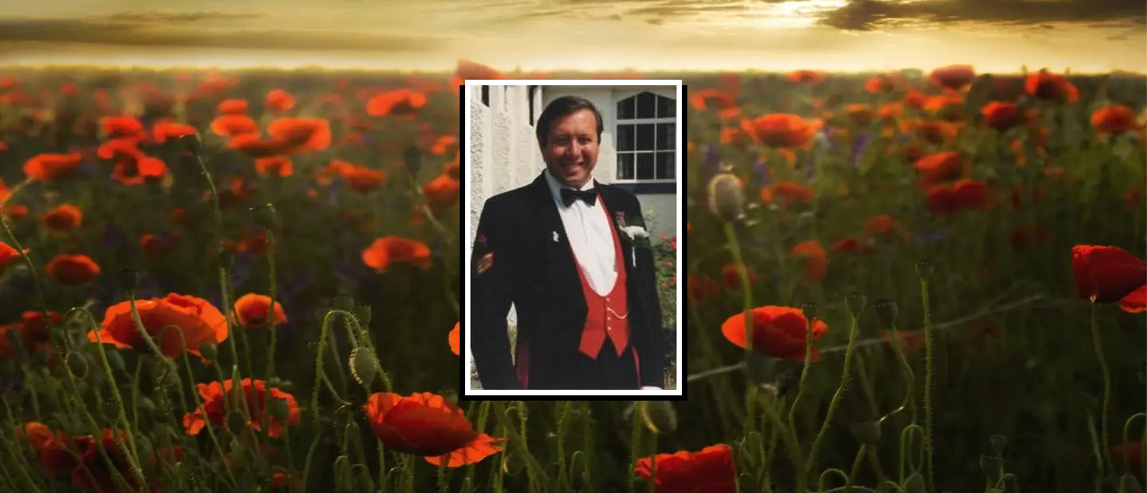 Photograph of Terry Luckman on a field of remembrance poppies